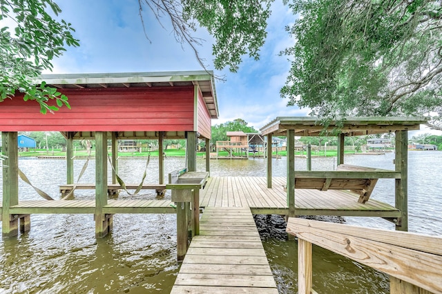 dock area with boat lift and a water view