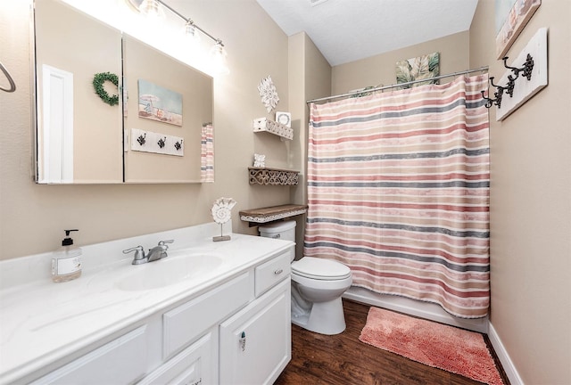 full bathroom featuring vanity, toilet, and wood finished floors