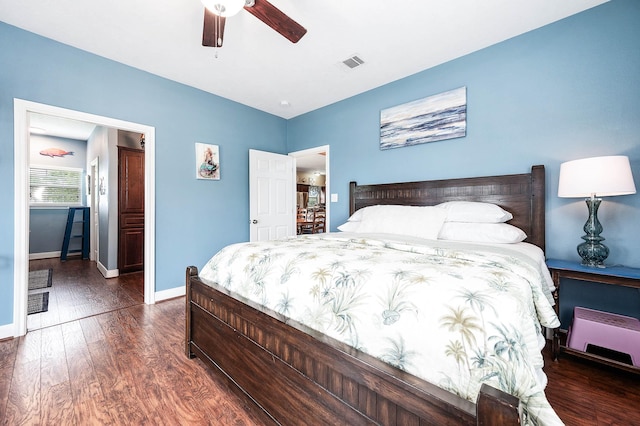 bedroom featuring baseboards, ceiling fan, visible vents, and dark wood-type flooring