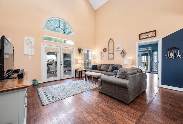 living room featuring high vaulted ceiling, hardwood / wood-style floors, french doors, and baseboards