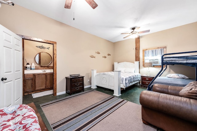 bedroom with cooling unit, connected bathroom, ceiling fan, and a sink