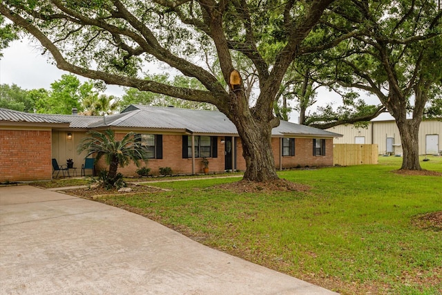 150 County Road 146, Alvin, TX 77511 - ranch-style home featuring metal roof, fence, brick siding, and a front yard