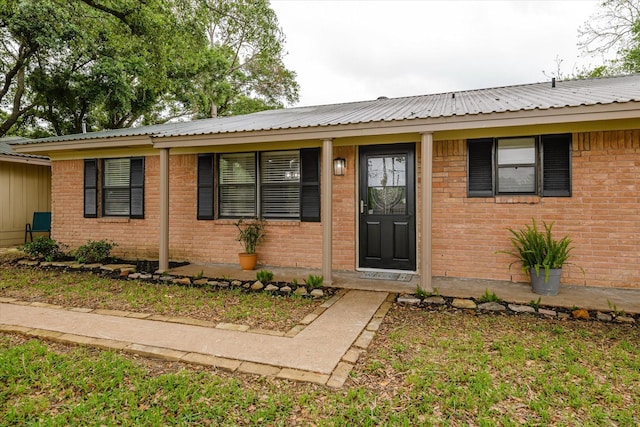 150 County Road 146, Alvin, TX 77511 - ranch-style house featuring metal roof and brick siding
