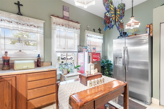311 Depot St, Dayton, TX 77535 - kitchen featuring stainless steel fridge with ice dispenser, light countertops, light tile patterned flooring, and decorative light fixtures