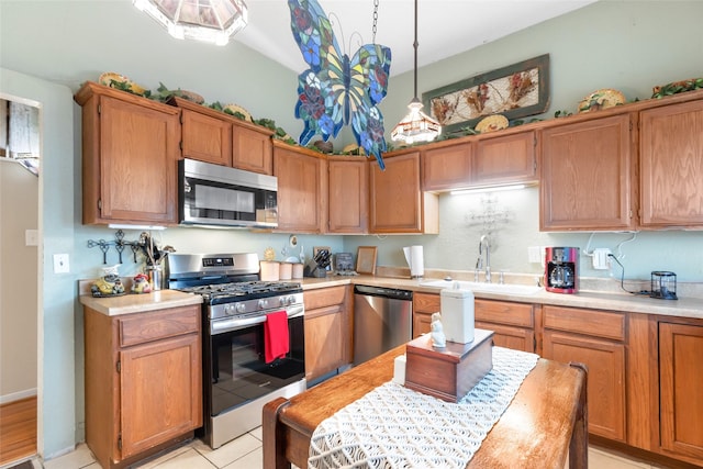 311 Depot St, Dayton, TX 77535 - kitchen with a sink, stainless steel appliances, light countertops, and light tile patterned floors