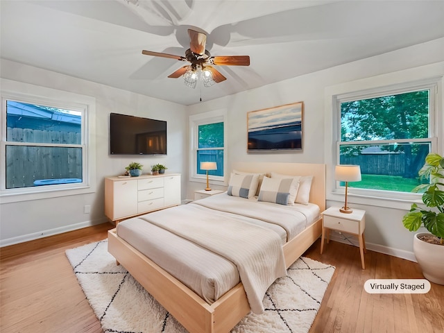bedroom with baseboards, a ceiling fan, and wood finished floors