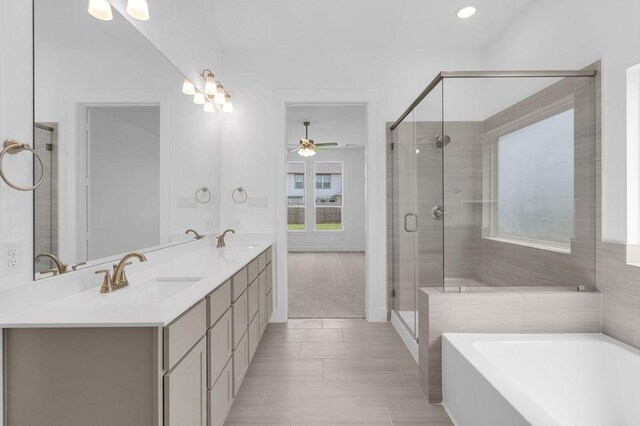 8114 Red Shiner Way, Fulshear, TX 77441 - full bathroom with a bath, double vanity, a ceiling fan, a stall shower, and recessed lighting