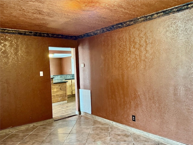 805 Dugas St, Bridge City, TX 77611 - tiled spare room with visible vents, baseboards, and a textured wall