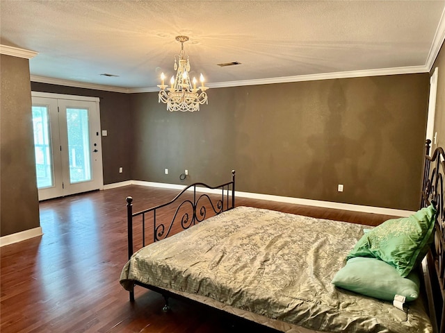 805 Dugas St, Bridge City, TX 77611 - bedroom featuring an inviting chandelier, visible vents, wood finished floors, and baseboards
