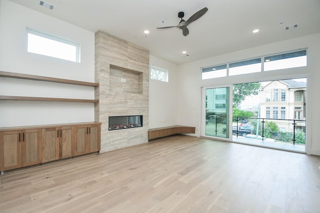 4709 Gibson St, Houston, TX 77007 - unfurnished living room featuring a ceiling fan, light wood-style floors, a fireplace, and recessed lighting