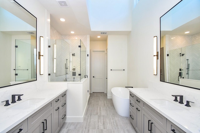 4709 Gibson St, Houston, TX 77007 - full bathroom with a stall shower, two vanities, a soaking tub, and recessed lighting