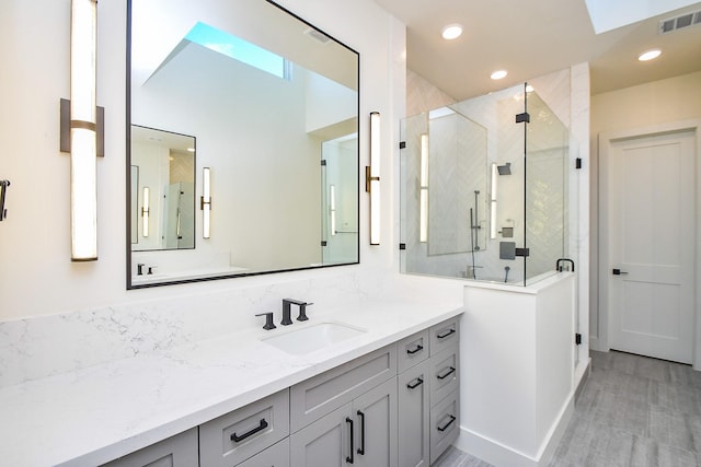 4709 Gibson St, Houston, TX 77007 - full bathroom with vanity, a stall shower, a skylight, and recessed lighting