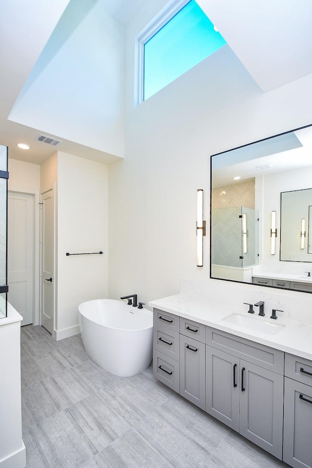 4709 Gibson St, Houston, TX 77007 - bathroom with vanity, a freestanding bath, and a walk in shower