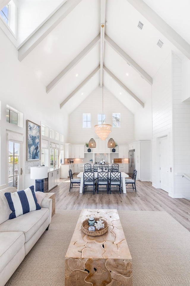 201 Lakeshore St, Port Aransas, TX 78373 - living area featuring beam ceiling, a notable chandelier, high vaulted ceiling, and light wood-style floors
