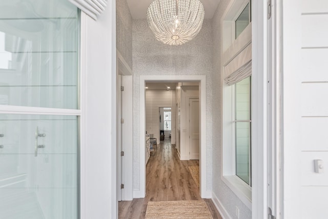201 Lakeshore St, Port Aransas, TX 78373 - hallway featuring a chandelier and wood finished floors