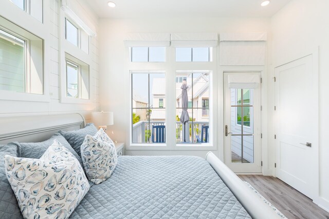 201 Lakeshore St, Port Aransas, TX 78373 - bedroom featuring multiple windows, wood finished floors, recessed lighting, and access to exterior