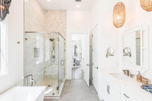201 Lakeshore St, Port Aransas, TX 78373 - ensuite bathroom with a soaking tub, tile patterned floors, a shower stall, and vanity