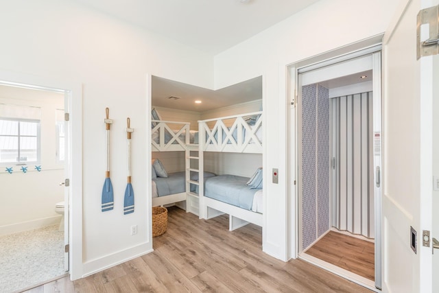 201 Lakeshore St, Port Aransas, TX 78373 - unfurnished bedroom with baseboards and light wood-type flooring