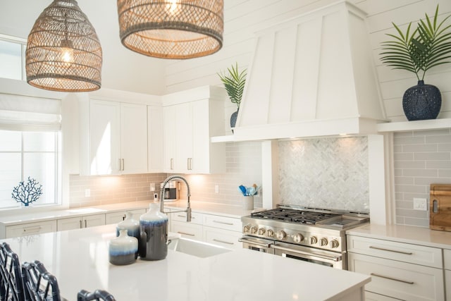 201 Lakeshore St, Port Aransas, TX 78373 - kitchen featuring double oven range, light countertops, tasteful backsplash, and a sink