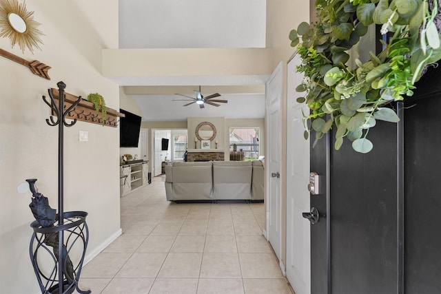 entryway featuring vaulted ceiling, ceiling fan, and light tile patterned flooring