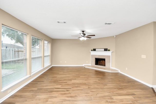 unfurnished living room with light wood finished floors, baseboards, ceiling fan, and visible vents