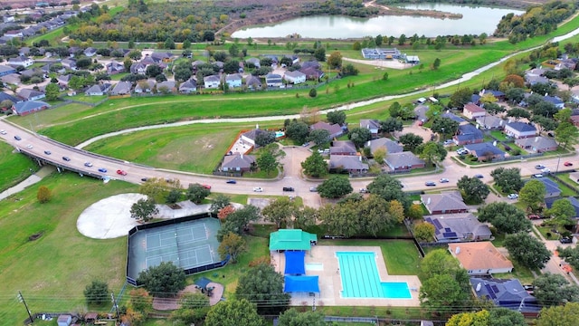 drone / aerial view with a water view and a residential view