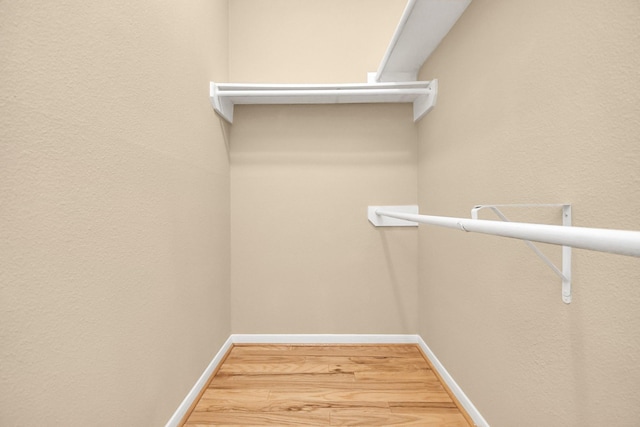 walk in closet featuring wood finished floors