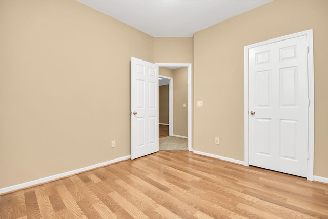 unfurnished bedroom featuring baseboards and light wood-type flooring