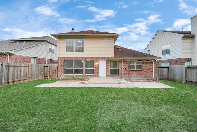 rear view of house with a patio area, brick siding, a lawn, and a fenced backyard