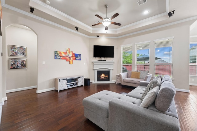 3743 Pinebrook Hollow Ln, Spring, TX 77386 - living room with a tray ceiling, visible vents, ceiling fan, a lit fireplace, and hardwood / wood-style floors