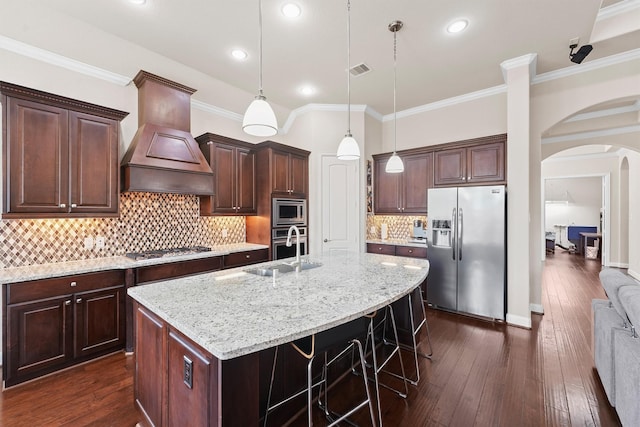 3743 Pinebrook Hollow Ln, Spring, TX 77386 - kitchen featuring visible vents, a sink, arched walkways, stainless steel appliances, and dark wood-style floors