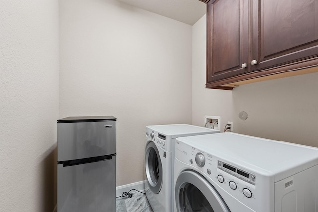 3743 Pinebrook Hollow Ln, Spring, TX 77386 - washroom with baseboards, washer and dryer, and cabinet space