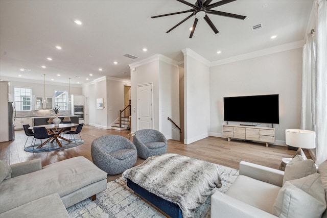 3606 Lannister Ln, Houston, TX 77055 - living area featuring ceiling fan, recessed lighting, ornamental molding, light wood-style floors, and stairs