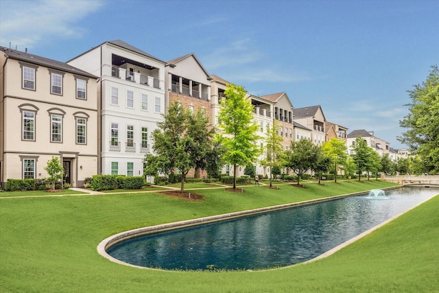 surrounding community featuring a yard and a water view