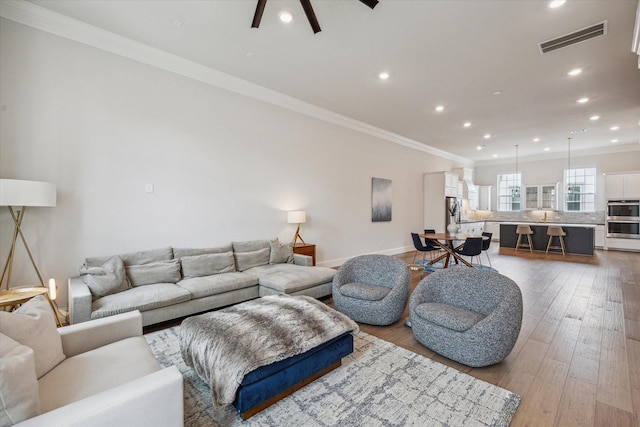 3606 Lannister Ln, Houston, TX 77055 - living room featuring recessed lighting, wood finished floors, ornamental molding, and ceiling fan