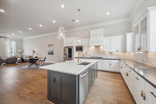 3606 Lannister Ln, Houston, TX 77055 - kitchen with stainless steel appliances, custom exhaust hood, white cabinetry, open floor plan, and tasteful backsplash