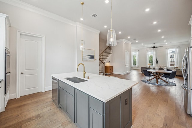 3606 Lannister Ln, Houston, TX 77055 - kitchen featuring gray cabinetry, crown molding, a kitchen island with sink, recessed lighting, and stainless steel appliances