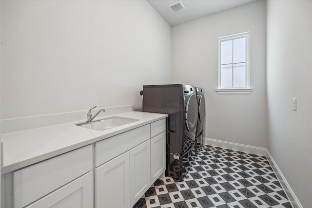 3606 Lannister Ln, Houston, TX 77055 - laundry room featuring washing machine and dryer, cabinet space, and tile patterned floors