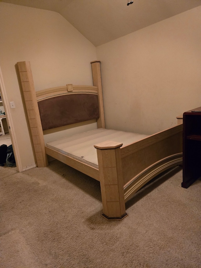 carpeted bedroom featuring vaulted ceiling