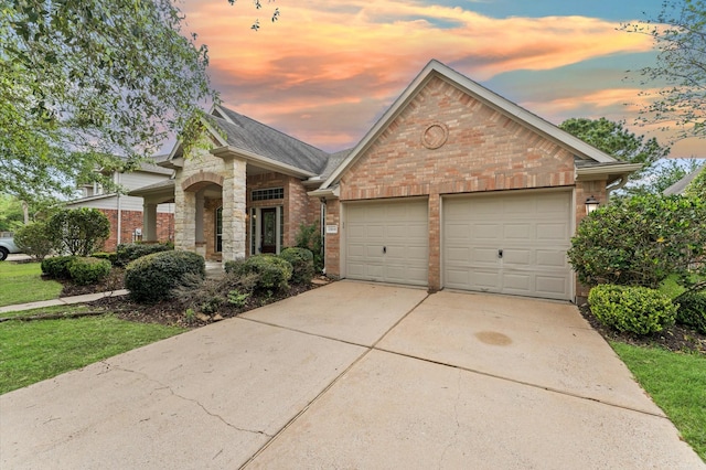 view of front of home with a garage, a shingled roof, brick siding, and driveway