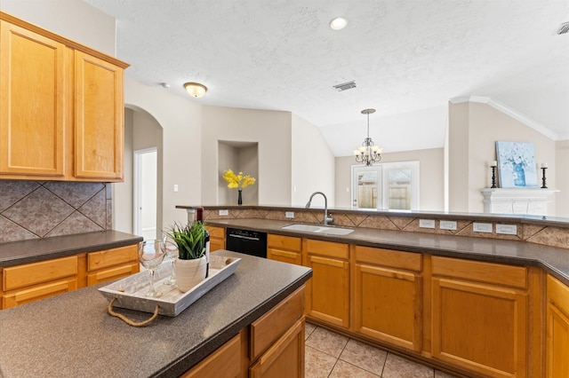 kitchen featuring a sink, dishwasher, an inviting chandelier, decorative backsplash, and dark countertops
