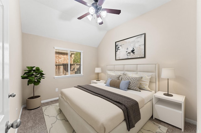 bedroom with light colored carpet, lofted ceiling, and baseboards