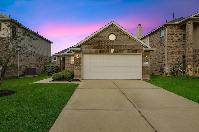 view of front of home featuring driveway, brick siding, a garage, central AC, and a front lawn