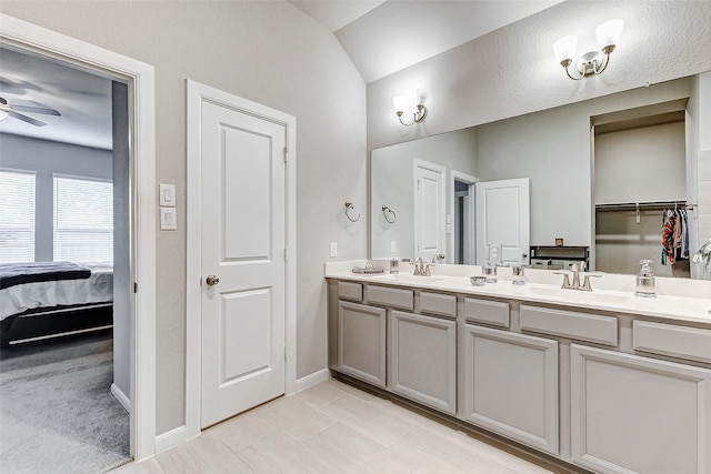 5110 Morrison Dr, Manvel, TX 77578 - full bathroom featuring double vanity, ensuite bathroom, ceiling fan, baseboards, and vaulted ceiling