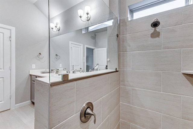 5110 Morrison Dr, Manvel, TX 77578 - bathroom with tiled shower, double vanity, tile patterned flooring, and lofted ceiling