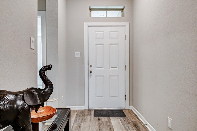 5110 Morrison Dr, Manvel, TX 77578 - entrance foyer with wood finished floors, a textured wall, and baseboards