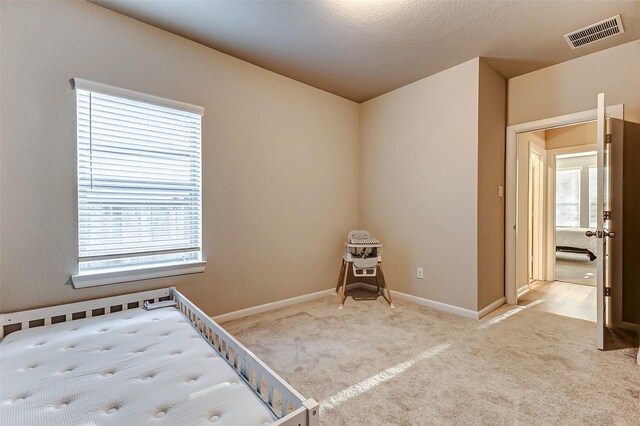 5110 Morrison Dr, Manvel, TX 77578 - unfurnished bedroom featuring multiple windows, carpet flooring, and baseboards