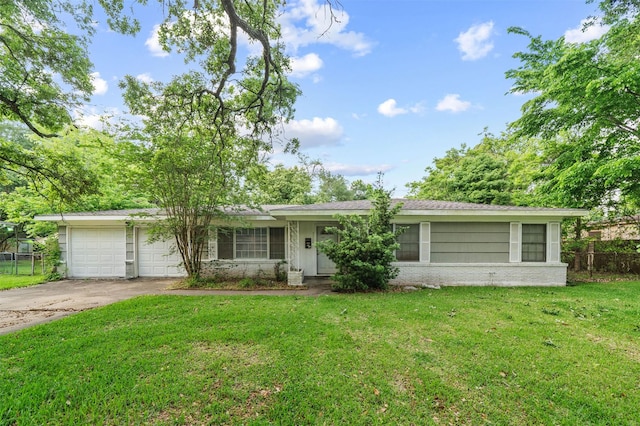 2310 Pecos St, La Marque, TX 77568 - ranch-style house featuring an attached garage, fence, a front yard, brick siding, and driveway