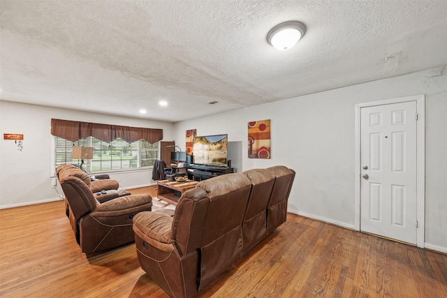 2310 Pecos St, La Marque, TX 77568 - living area with baseboards, a textured ceiling, and wood finished floors
