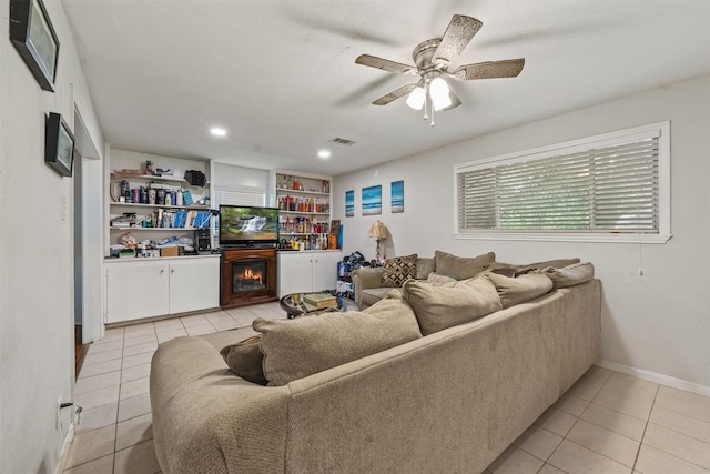 2310 Pecos St, La Marque, TX 77568 - living room featuring a warm lit fireplace, visible vents, recessed lighting, ceiling fan, and light tile patterned floors